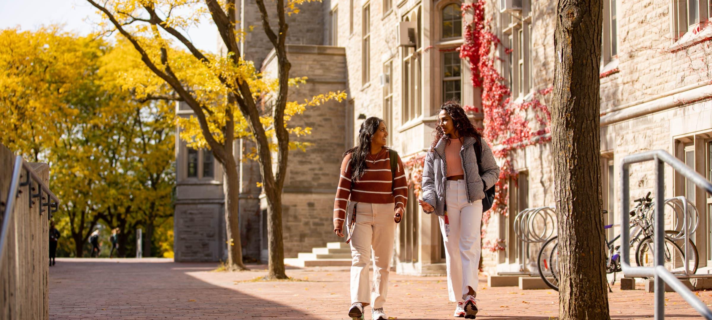 Two students walking outside Residence