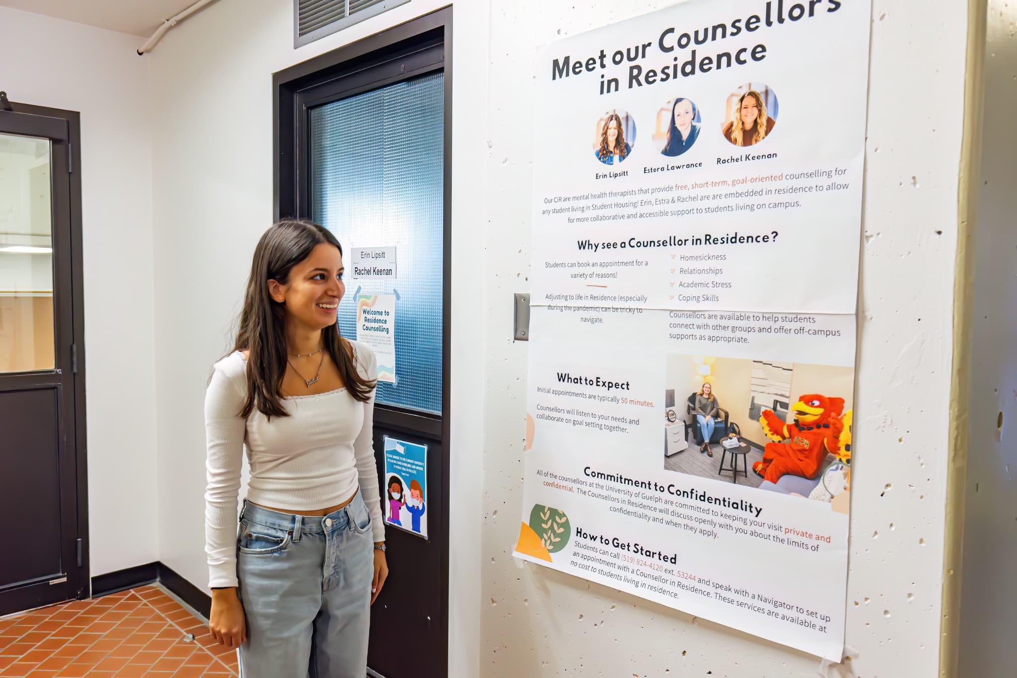 Student standing outside counsellors office in south residence