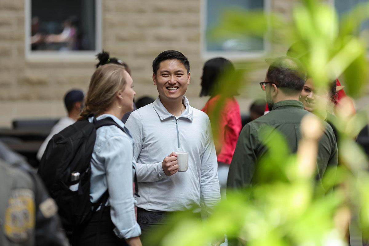 A group of people smiling and talking.