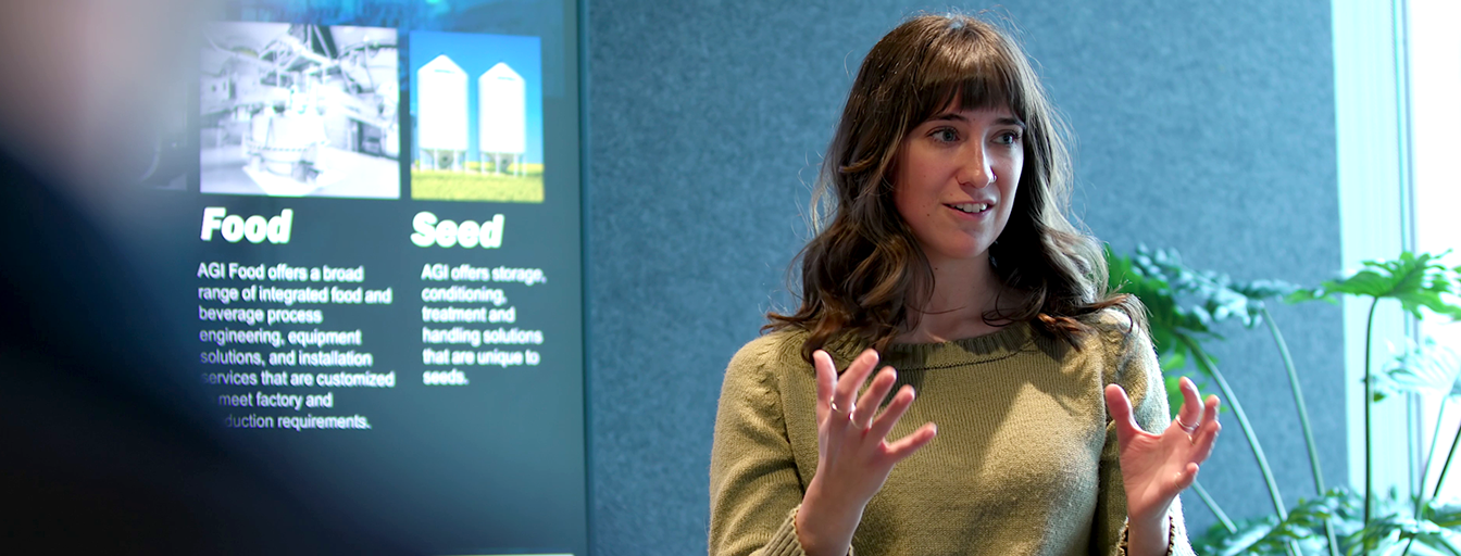 mikayla in  a boardroom giving a speech