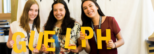 Students holding "GUELPH" letters