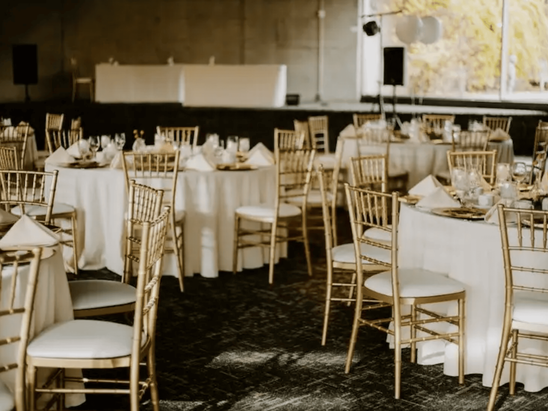 Arboretum event with gold chivari chairs and white linened tables