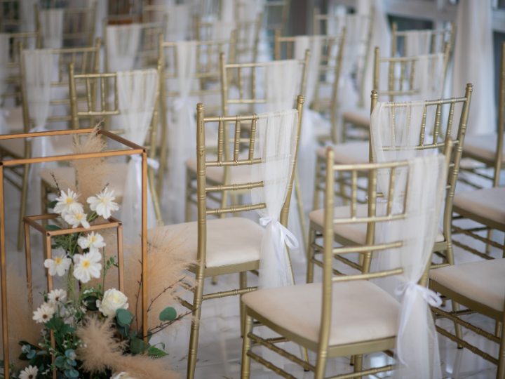 chairs placed in rows and dressed for a wedding ceremony.