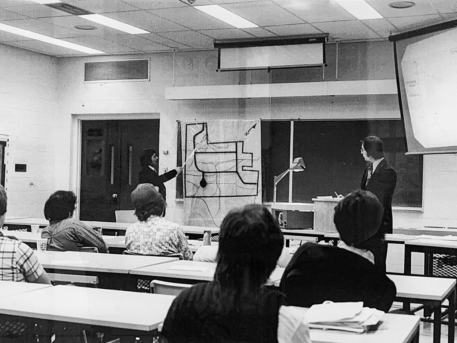 old black and white photo of a professor giving a lecture