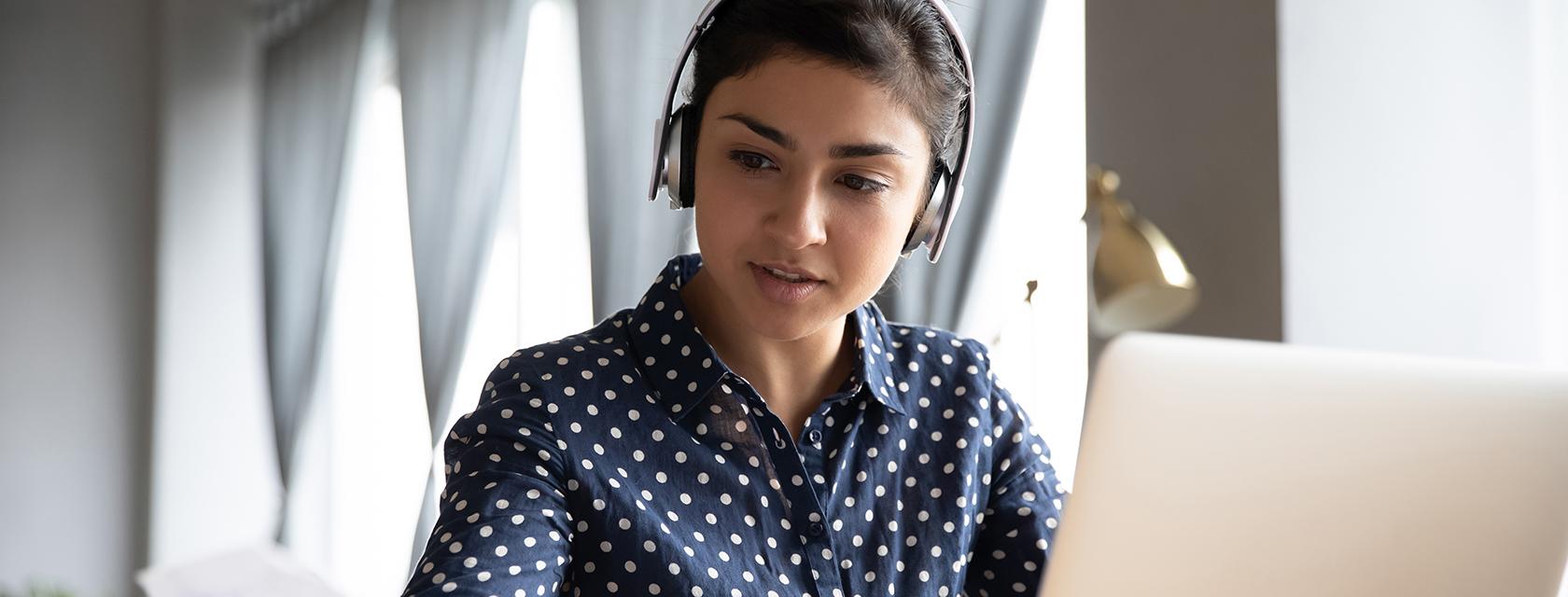 Young woman studying on a laptop.