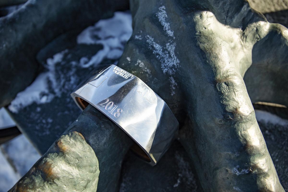 Close-up of the newly designed ring on the gryphon claw, showing the engraved UofG logo, 2018 and 2019