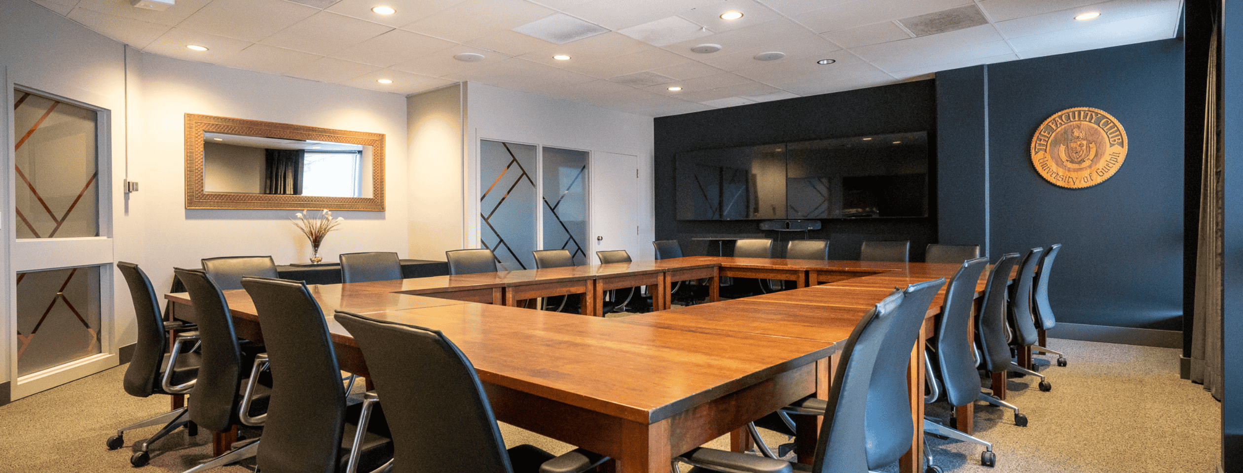 University club VIP room, tables set up as a hollow square with black chairs