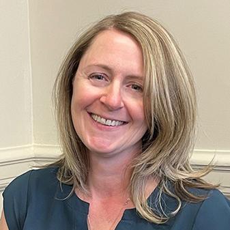 Blond woman smiling.