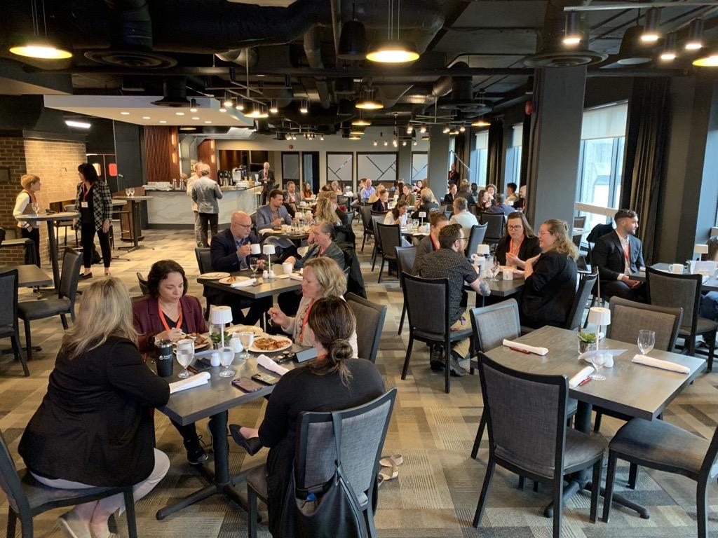 Conference attendees eating breakfast at the University Club.