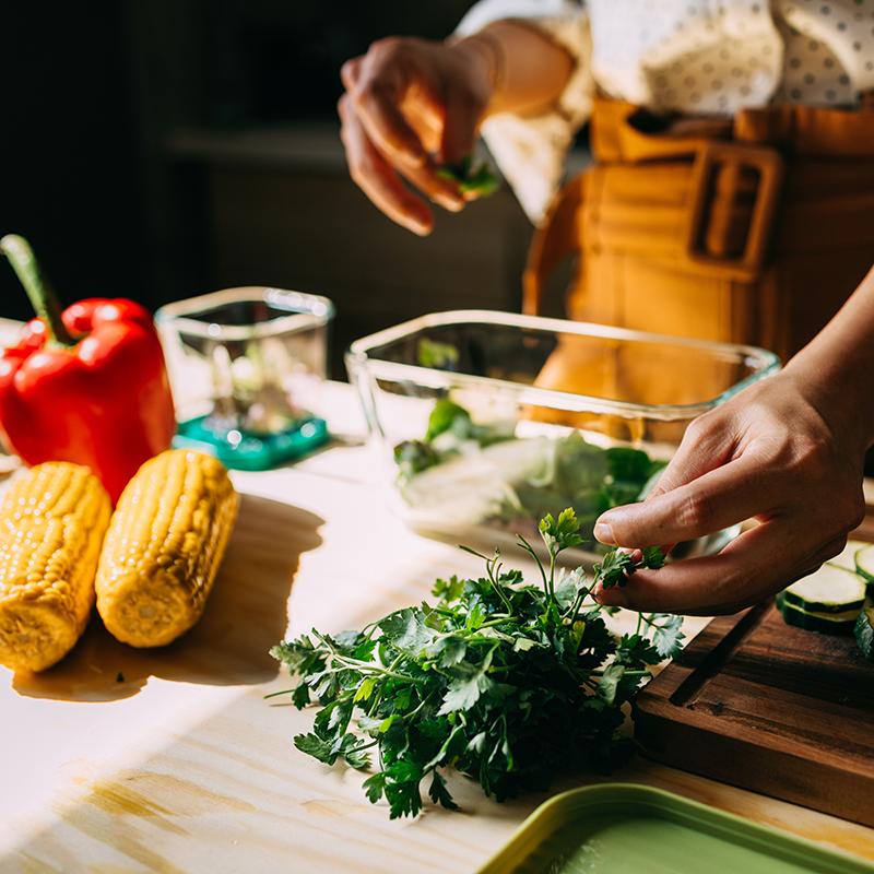 Closeup of a person cooking a plant-based meal.