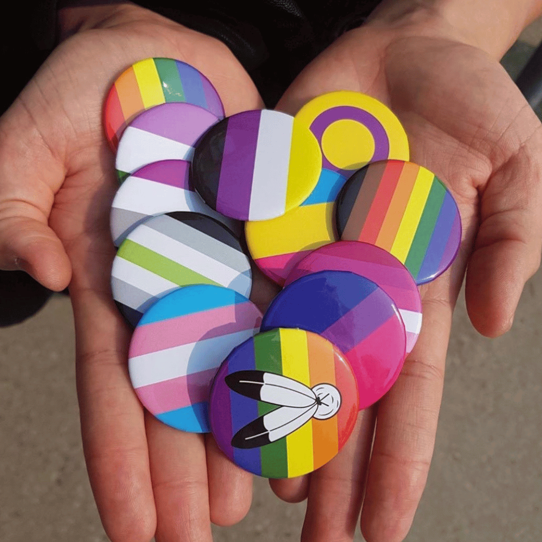 pride idenity pins in hands