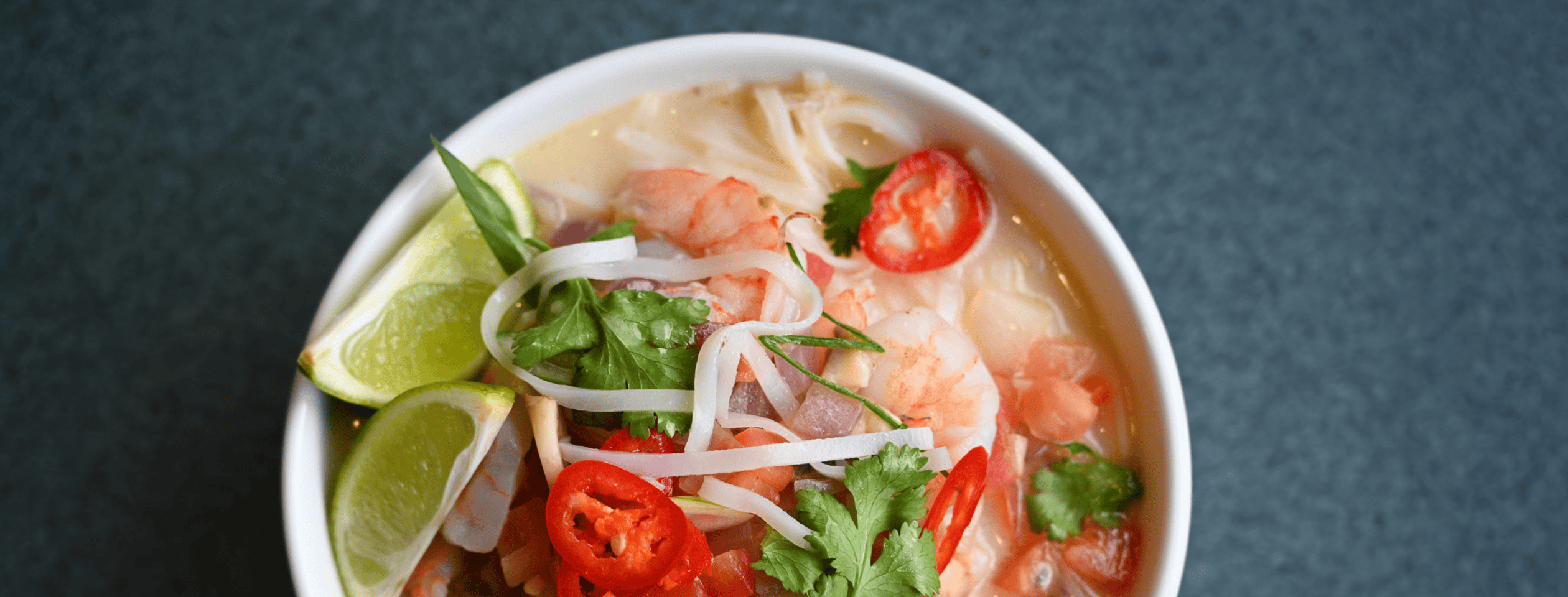 bowl of pho on blue background