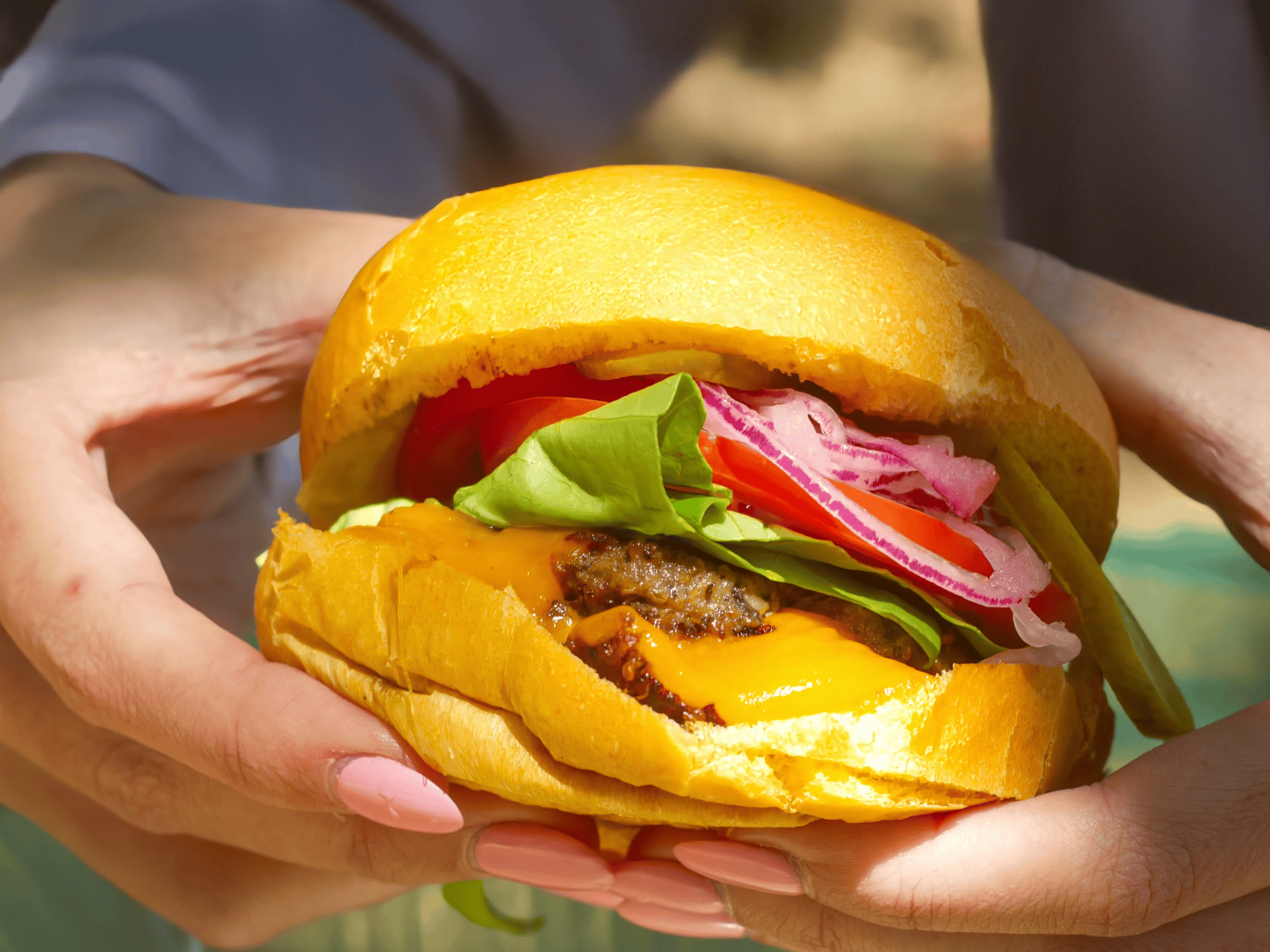 Sustainable Smash Burger being held