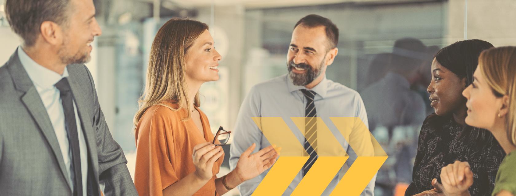 Group of employees listening to their manager during a meeting.