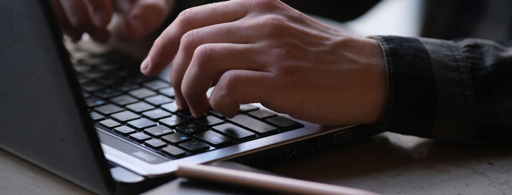 hands typing on keyboard