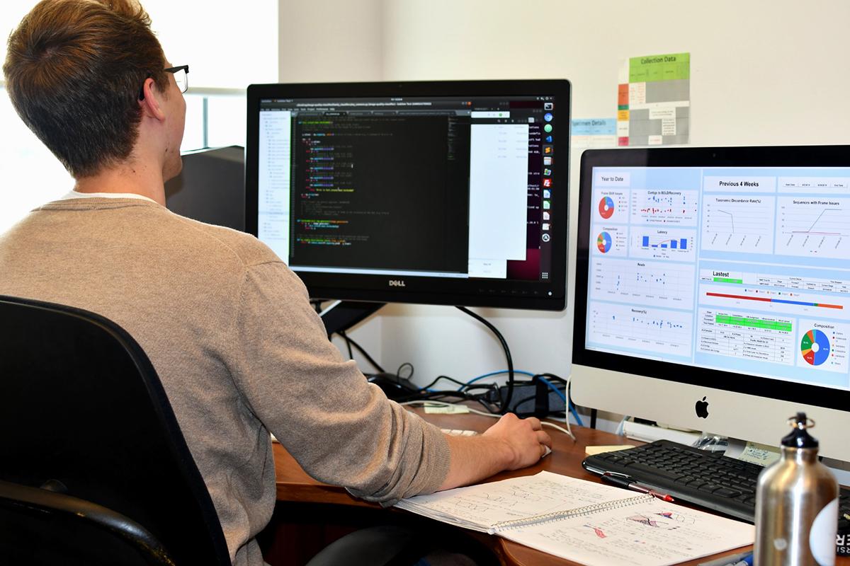 A man working with reports on computer