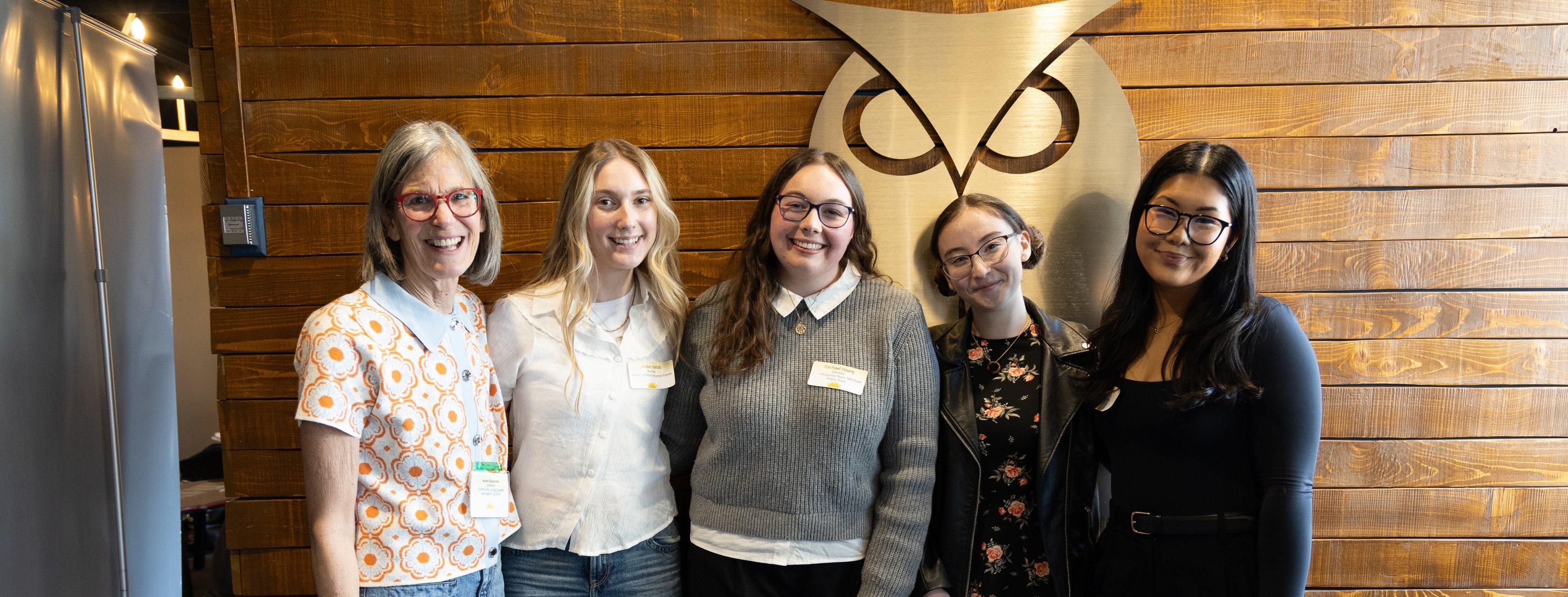 A photo of 5 award winners smiling together.