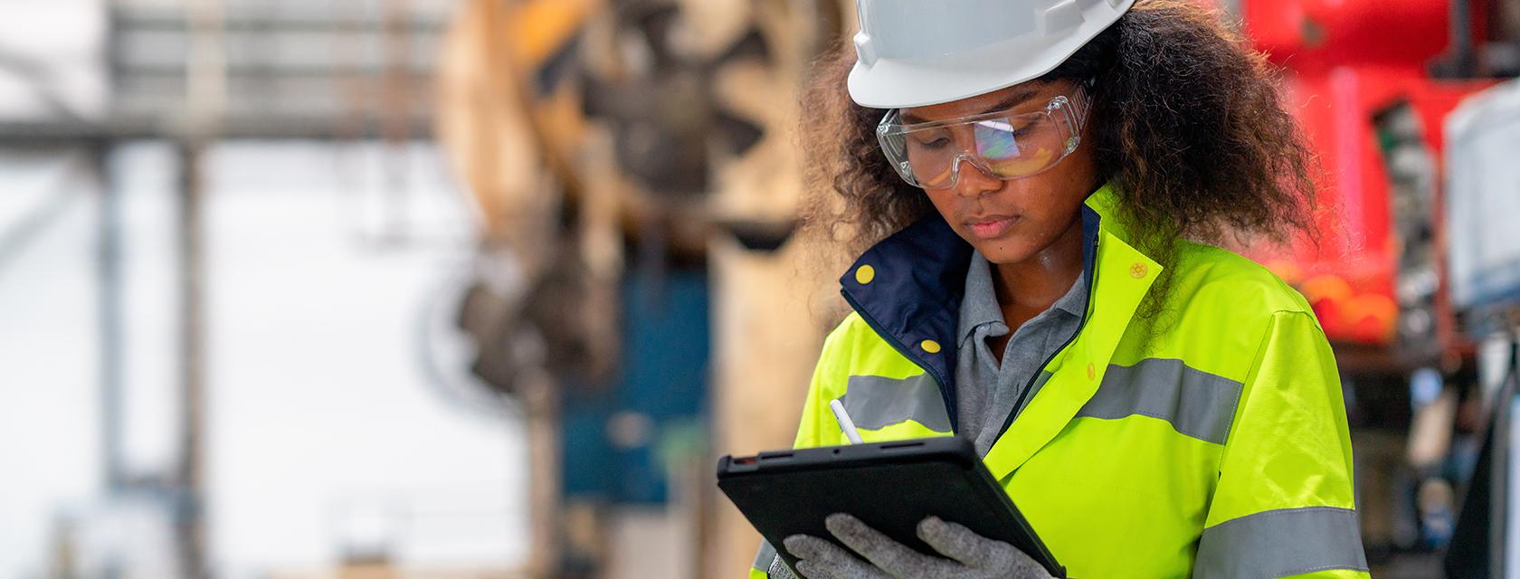 Young woman conducting a quality inspection in a manufacturing setting.