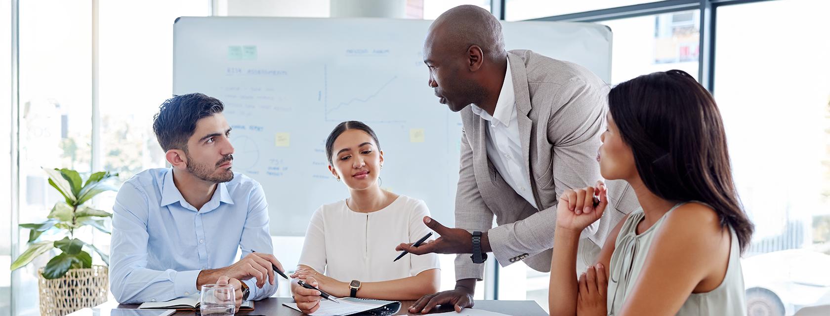 Group of professionals around a board room table.