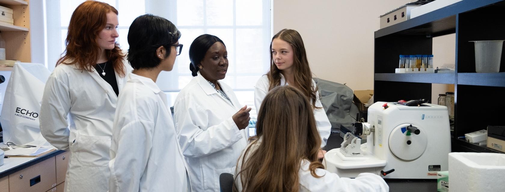 students and prof in a lab
