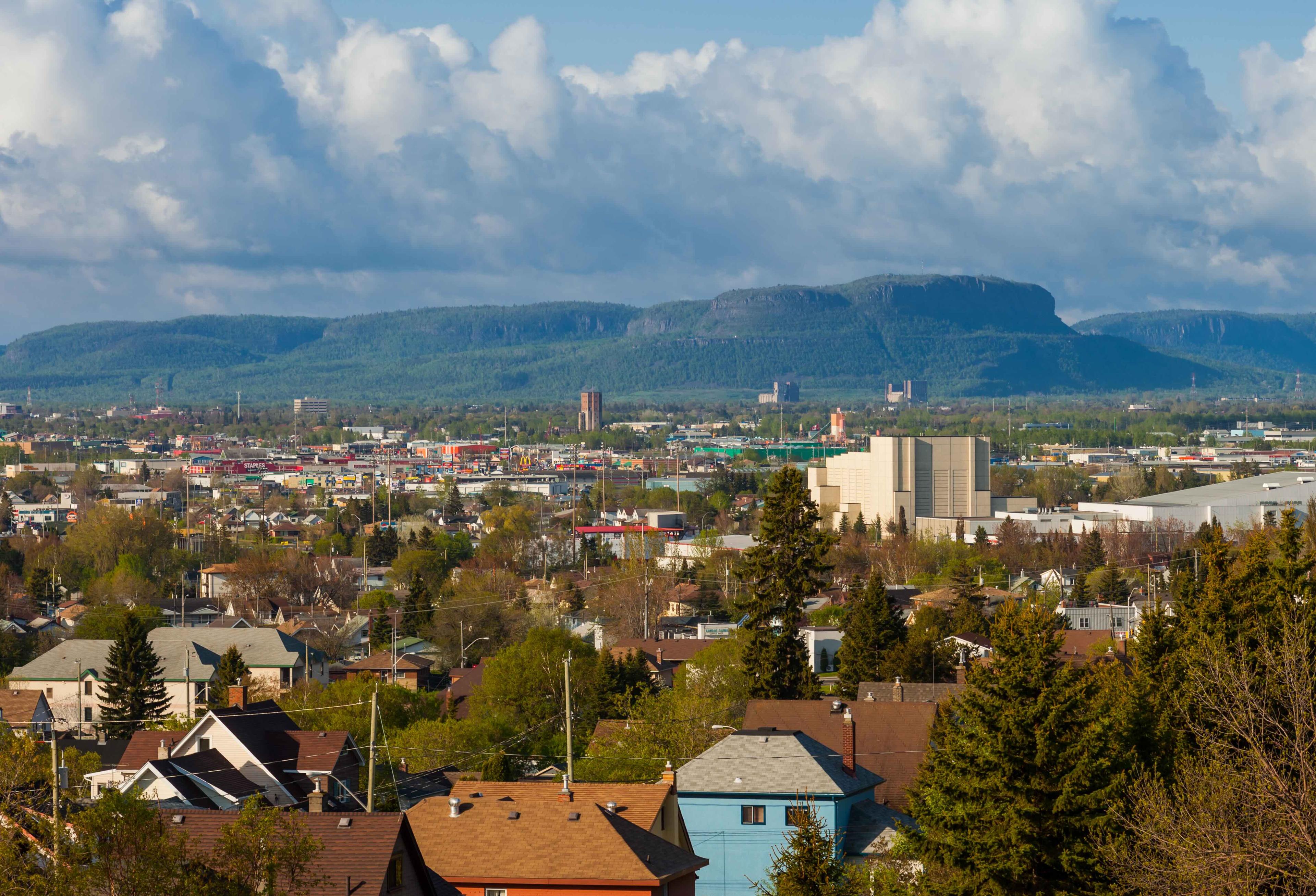 wide shot of Thunder Bay town and mountain in the background on a day with a mix of sun and clouds