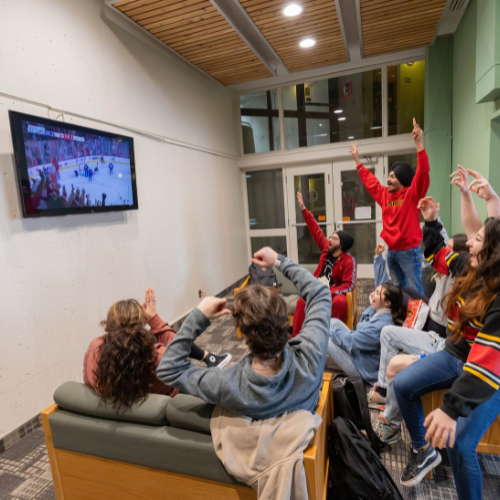 students watching TV in the lounge area