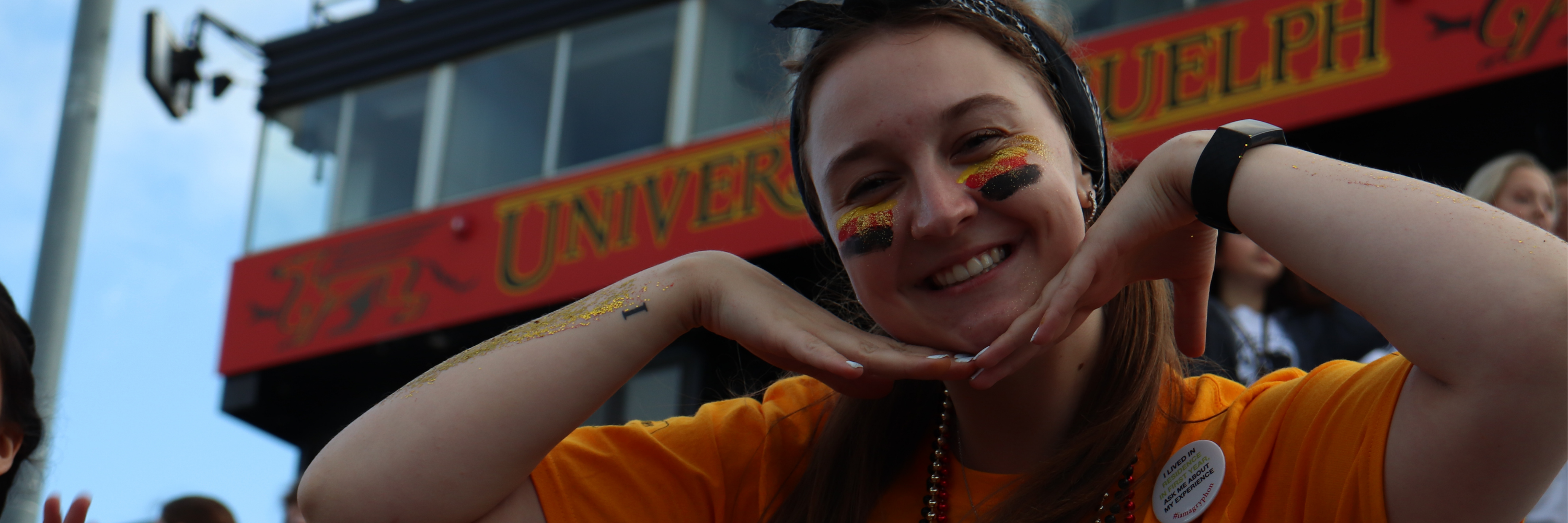 An orientation volunteer smiling at the Pep Rally