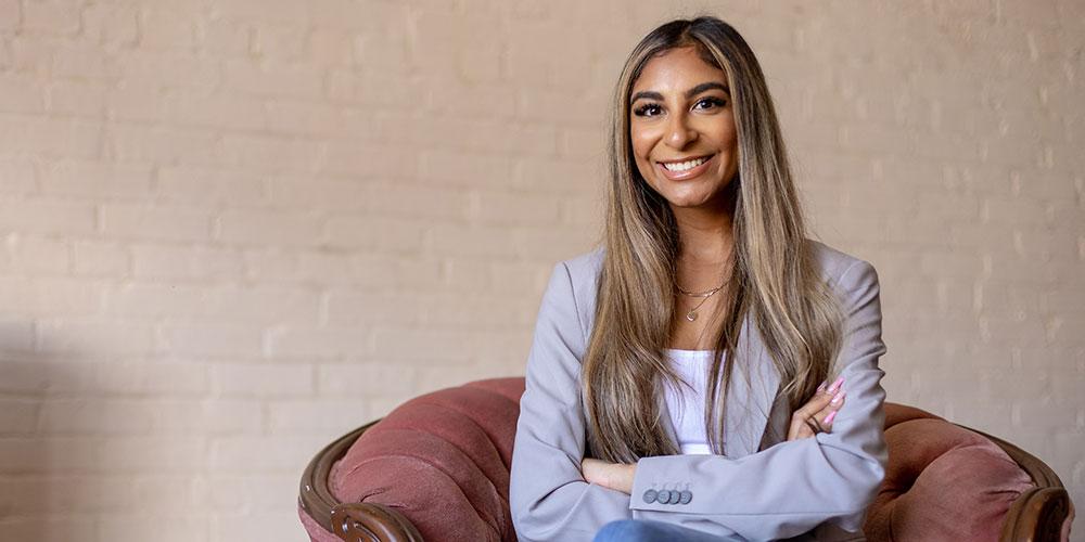 Lang business school alumni Tara Lalani sitting smiling.
