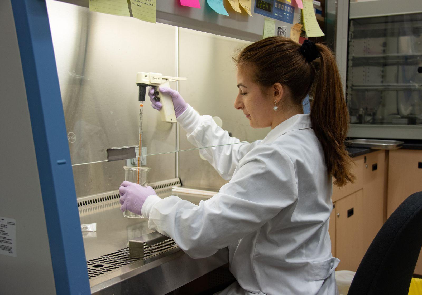 Student in lab pipet