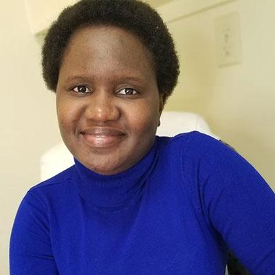 Busayo in blue turtleneck sweater