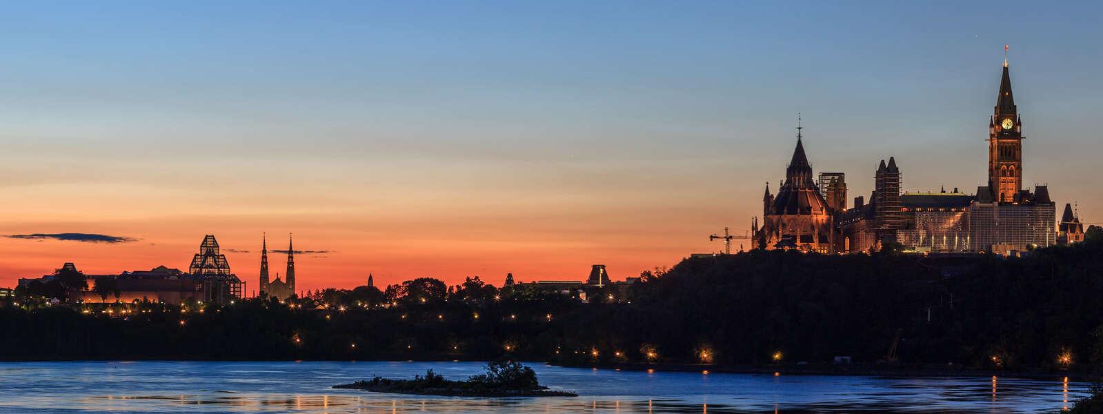a photo of Ottawa's skyline with the Parliament buildings in the distance