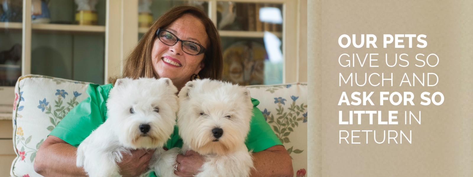 Lindy holding 2 small dogs and text beside that saying "Our pets give us so much and ask for so little in return"