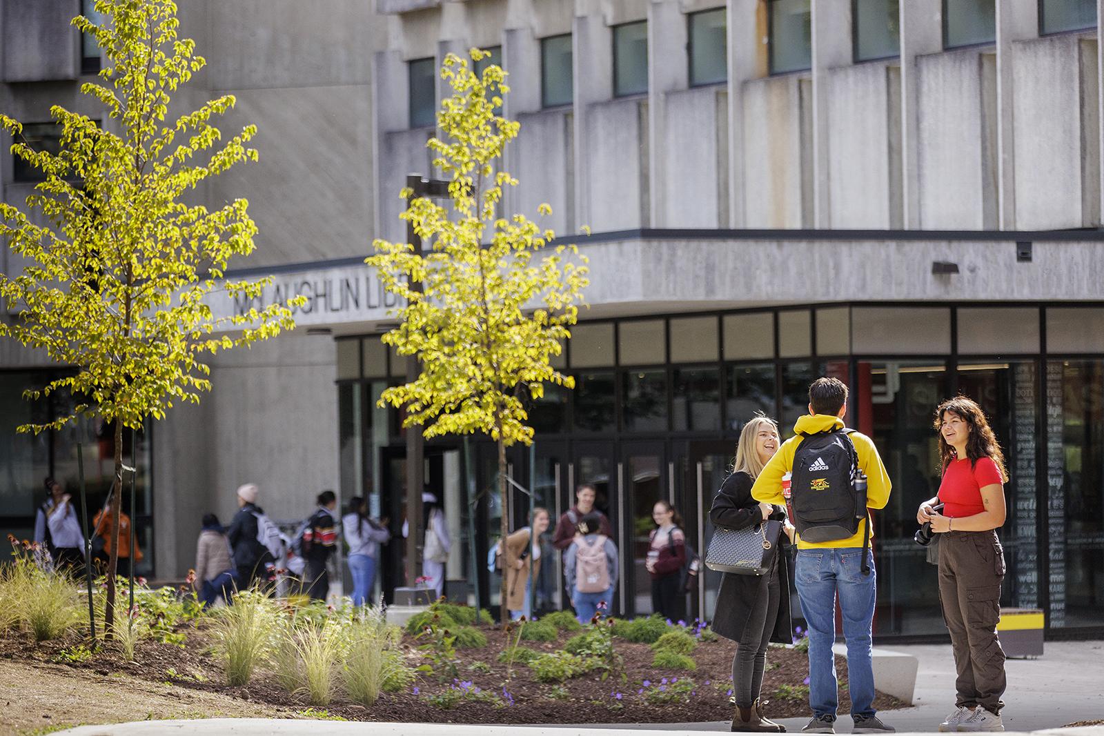 Students talking outside the McLaughlin Library