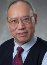 Headshot of man wearing tie.