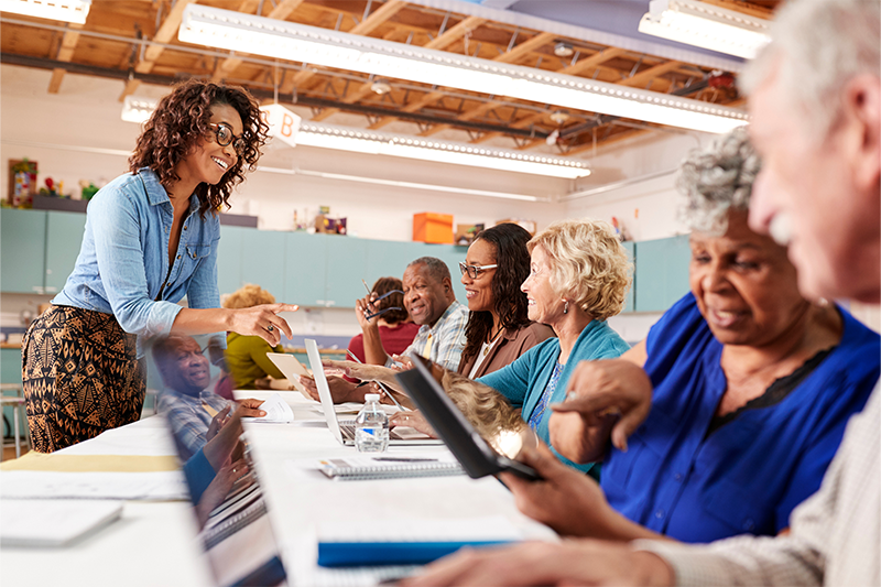 a staff member works with seniors at the community centre