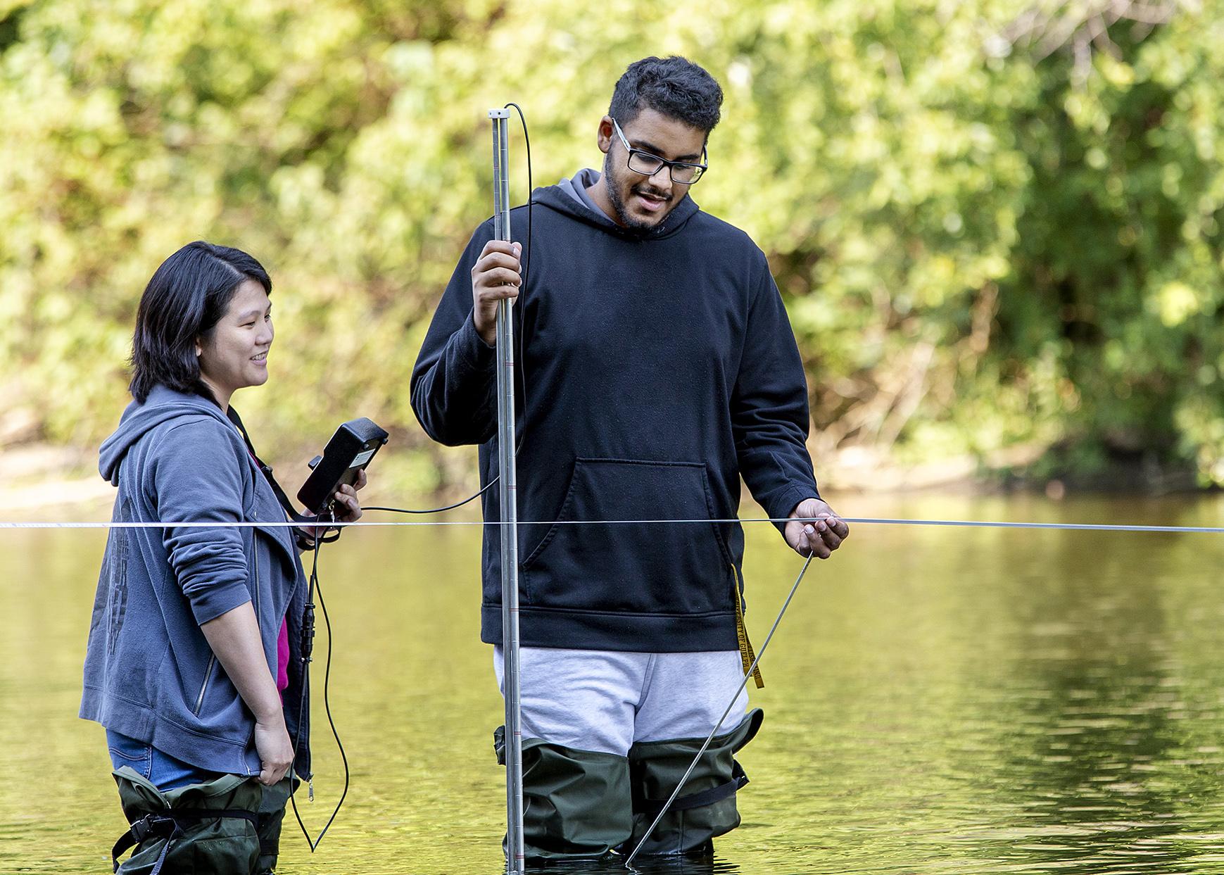 Two engineering students dong stream gauging