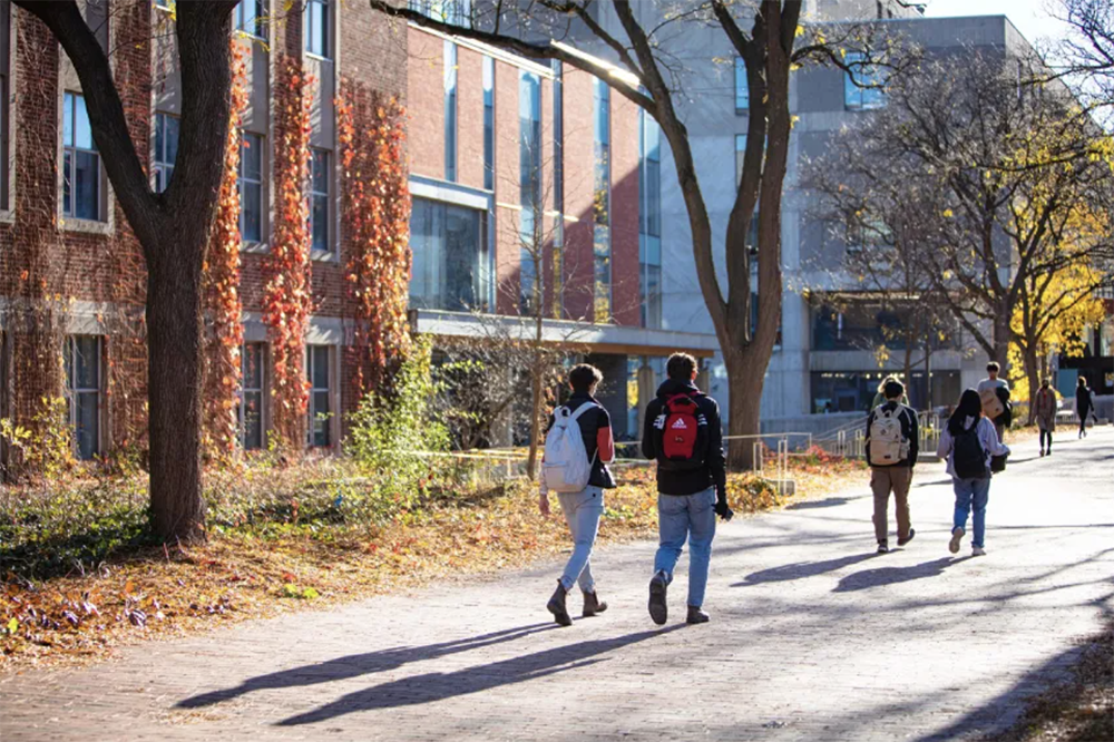 Students walking past Thornbrough building in the fall
