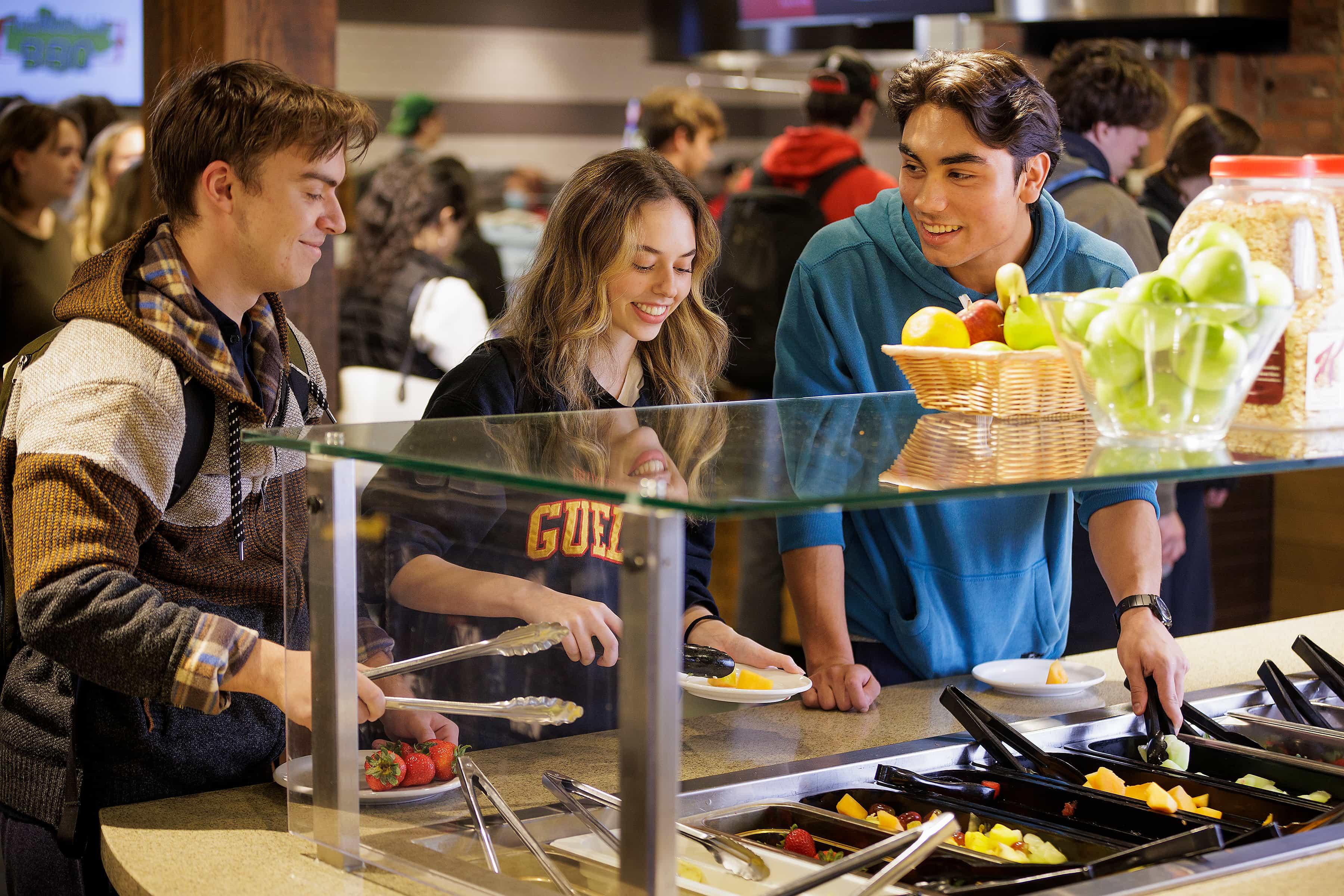 Students getting food from the buffet at Creelman Hall