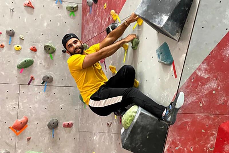 A University of Guelph Student on the Indoor Rock Climbing Wall at the GGAC