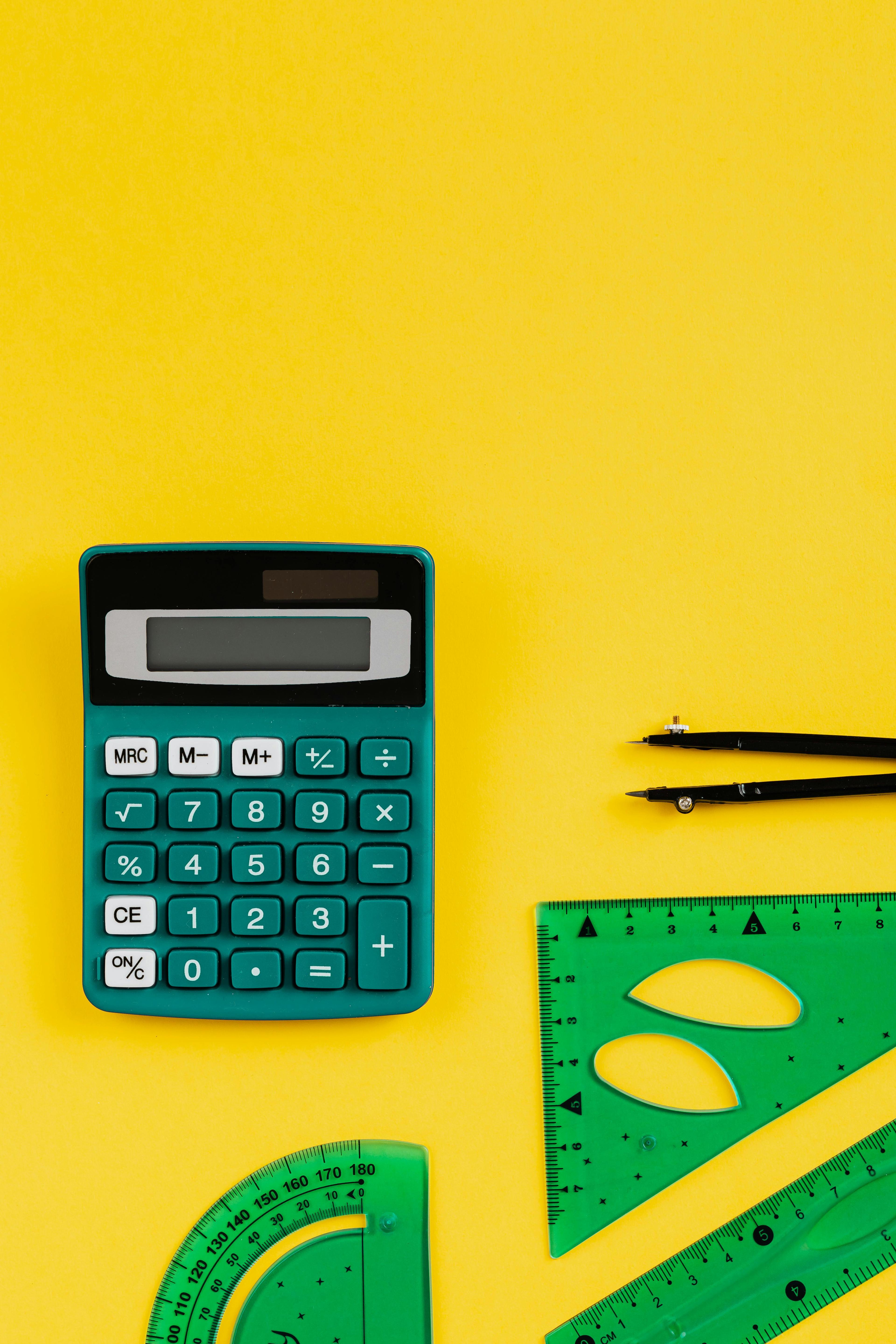 Calculator and rulers on yellow background