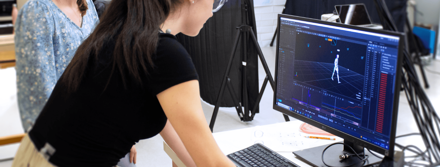 Two students looking at motion software on a computer screen
