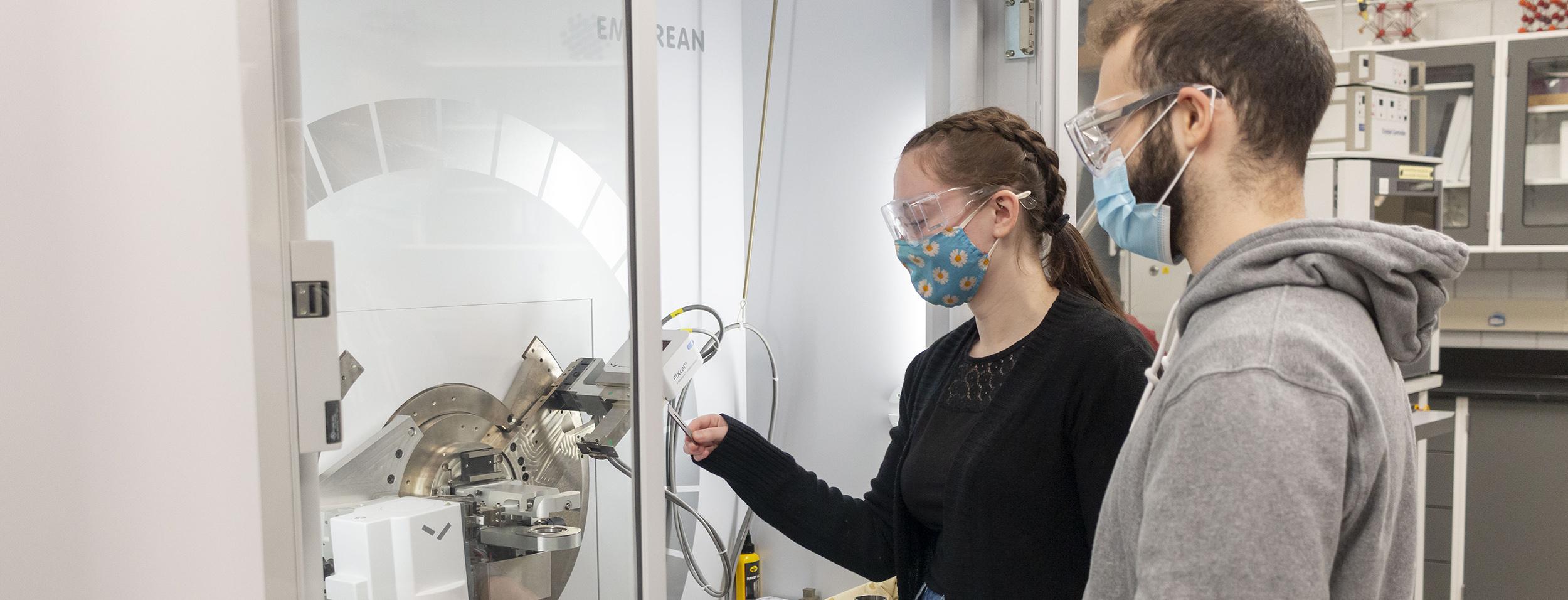 Two graduate students are together in a crystallography lab in the Department of Chemistry