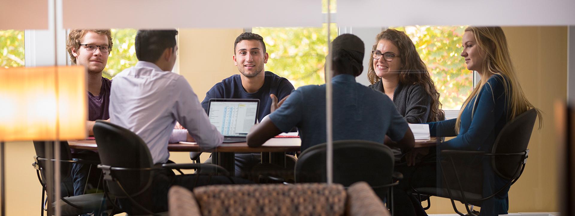 Multiple students studying together at a library