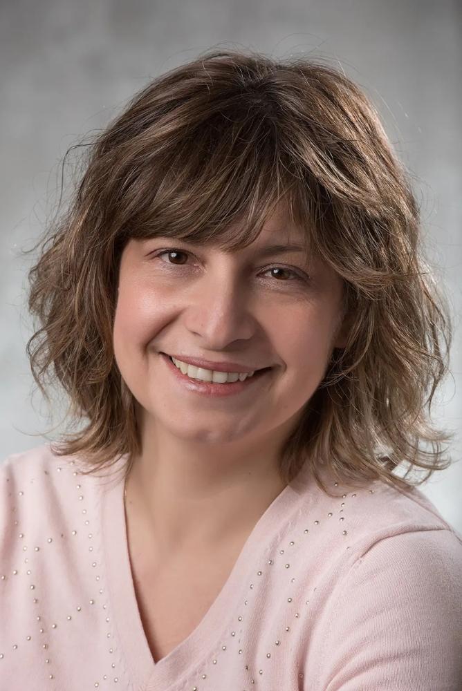 Dr. Monica Cojocaru smiling.