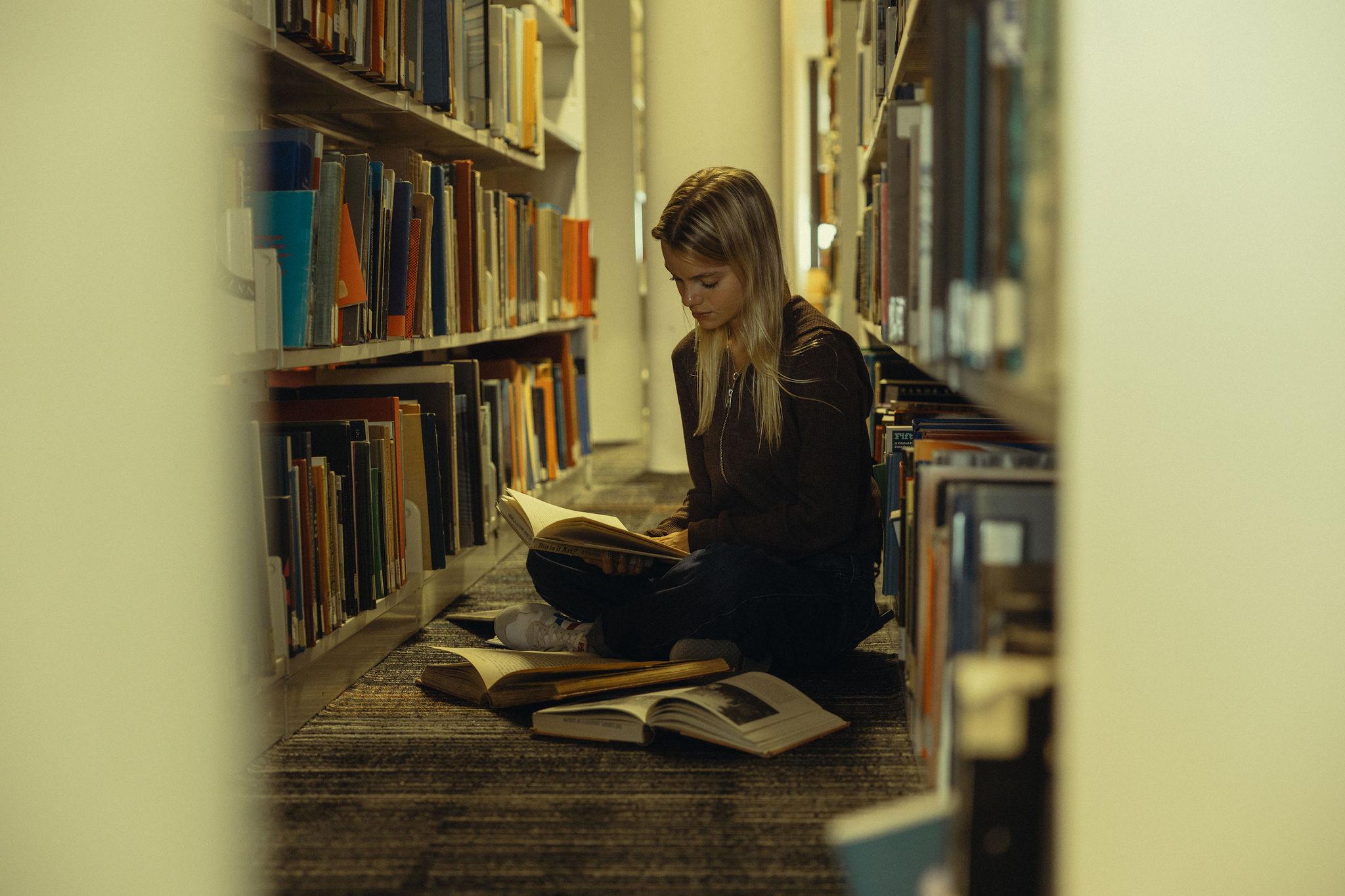 student reading in the library