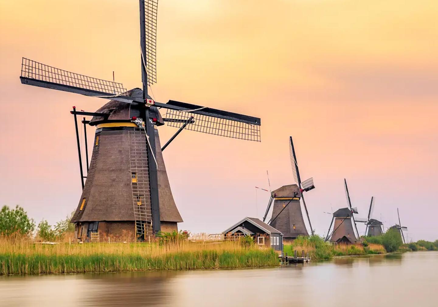 Windmills along river in the Netherlands